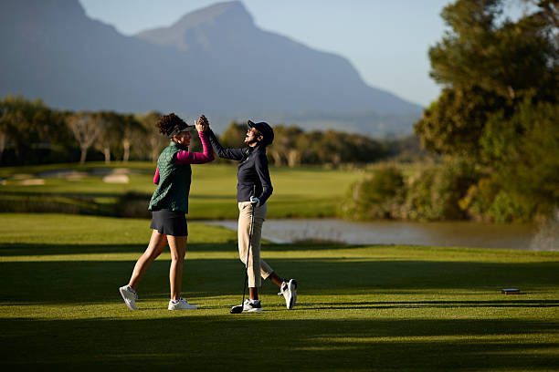 2 black women tennis players having fun on the golf course.